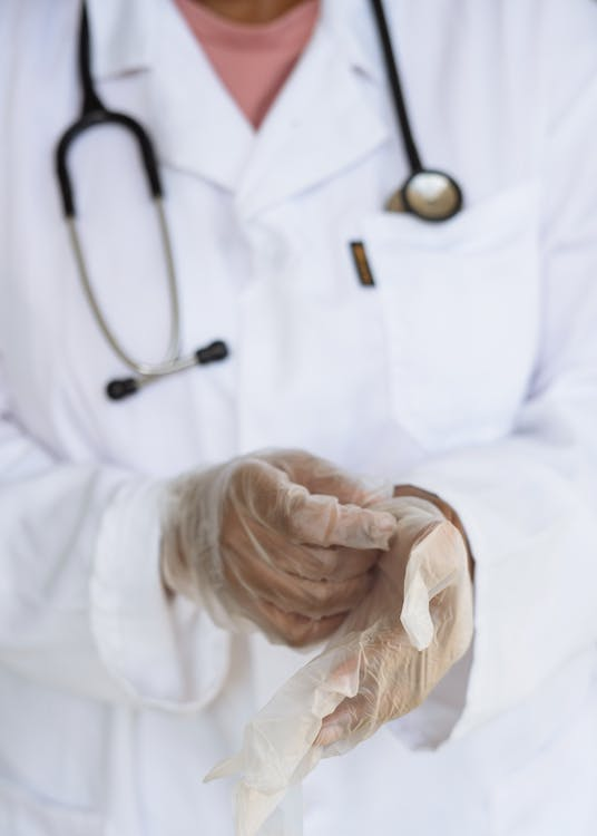 An image of a doctor wearing gloves