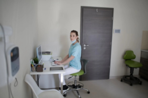 A photo of a woman sitting on a chair at her desk
