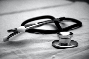 A photo of a stethoscope on a gray background