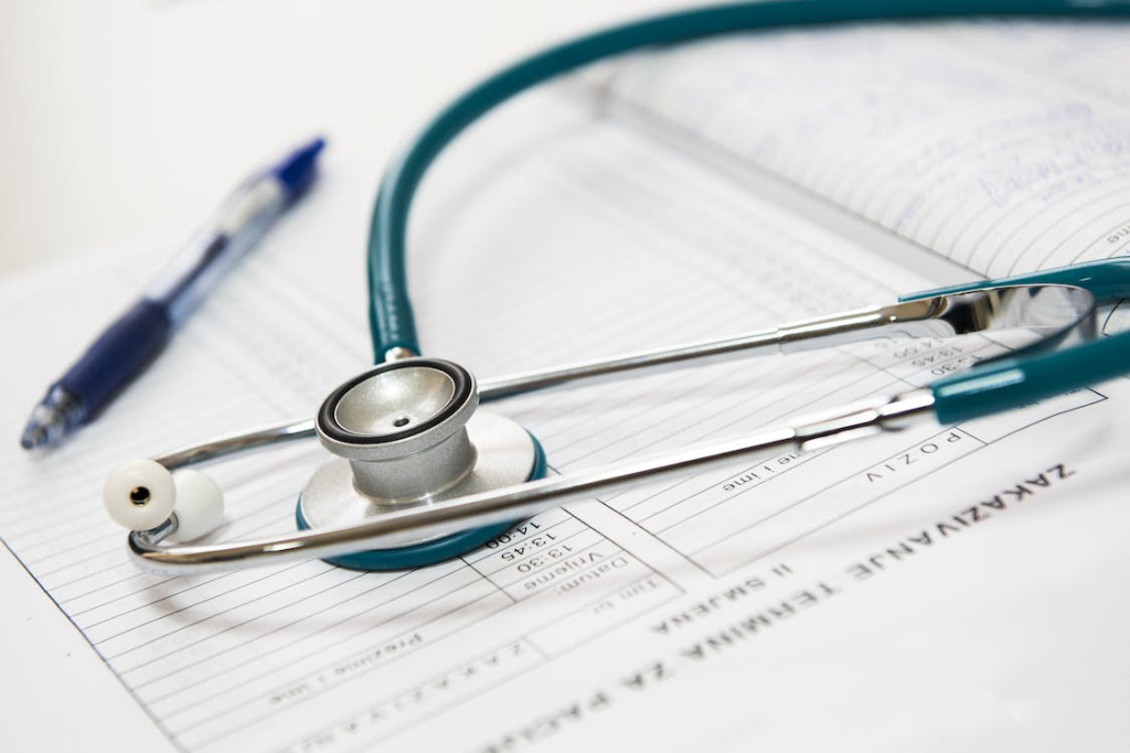 Stethoscope and pen placed over a document