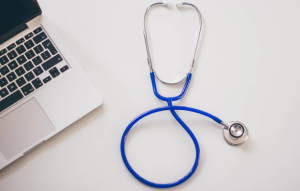 a stethoscope next to a laptop