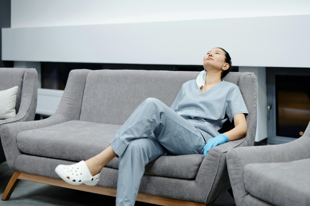 a nurse sitting down on a sofa