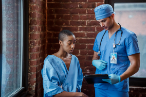 a doctor holding a clipboard and showing it to the patient