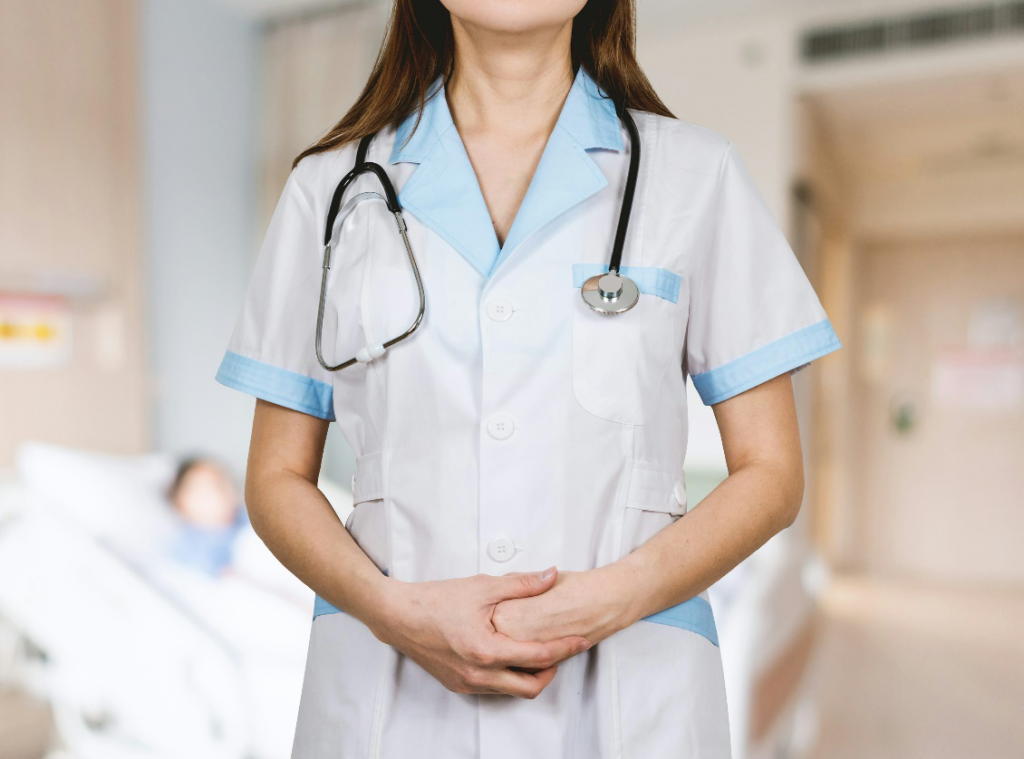 A female doctor wearing a white shirt and blue stethoscope.