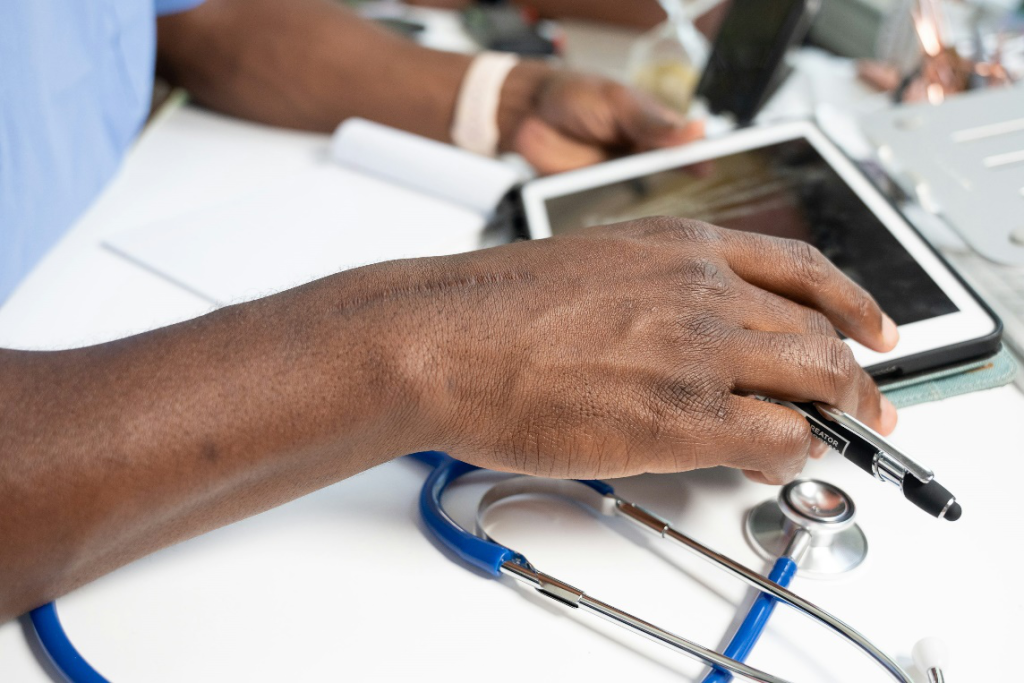 Doctor reviewing an X-ray on a tablet while holding a pen.